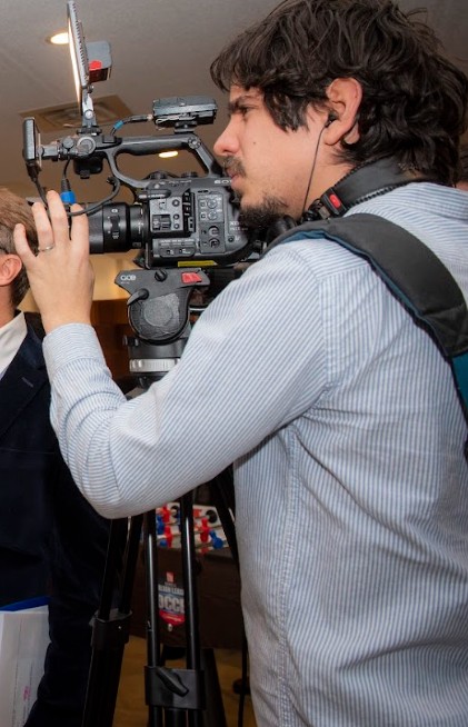 Andres operating a cinema camera on a tripod