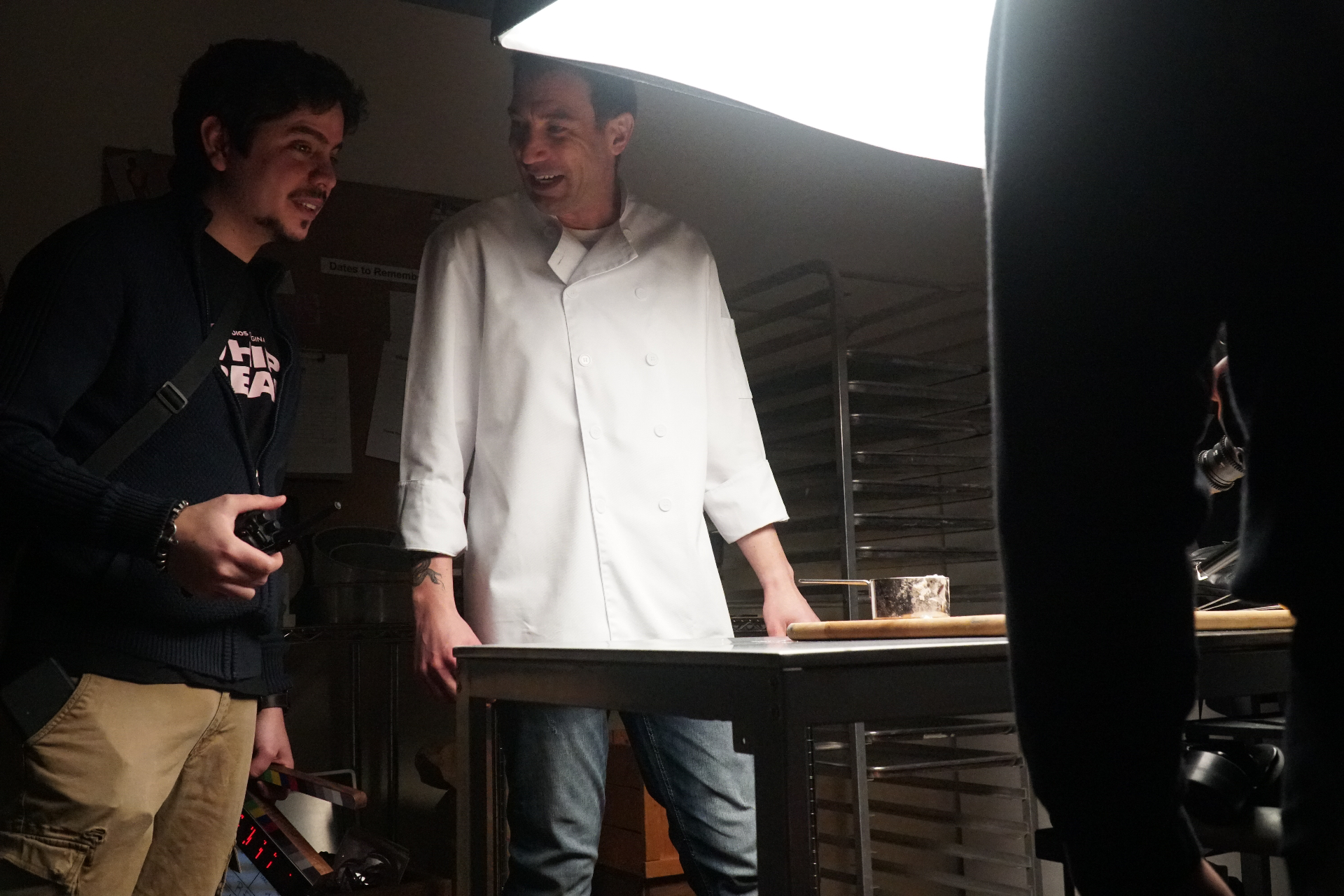 Andres directing a chef during a food shoot under a softbox.